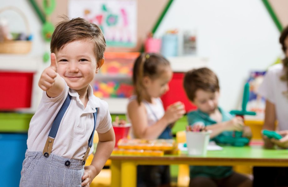 Happy child in preschool classroom.
